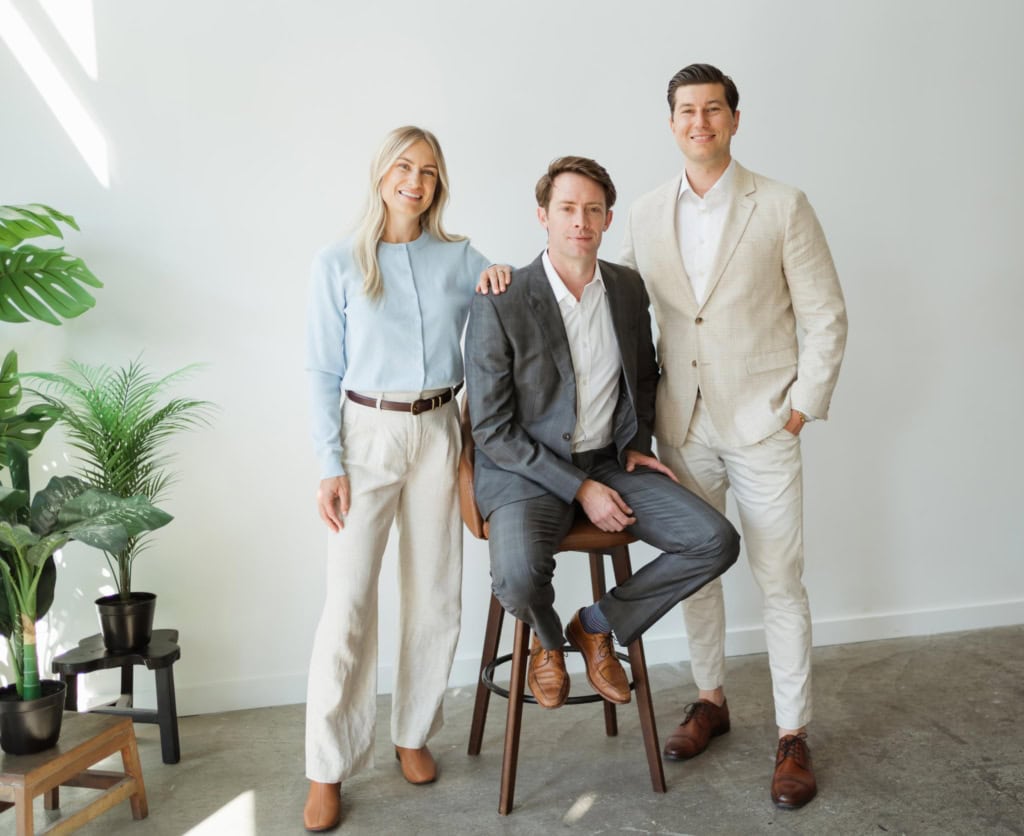 Ricki-Lee Jewell, Steven Reilander, and Alex Hughes from the North Pacific Homes Group, with eXp Realty, in Victoria, BC, pose together for a photo.