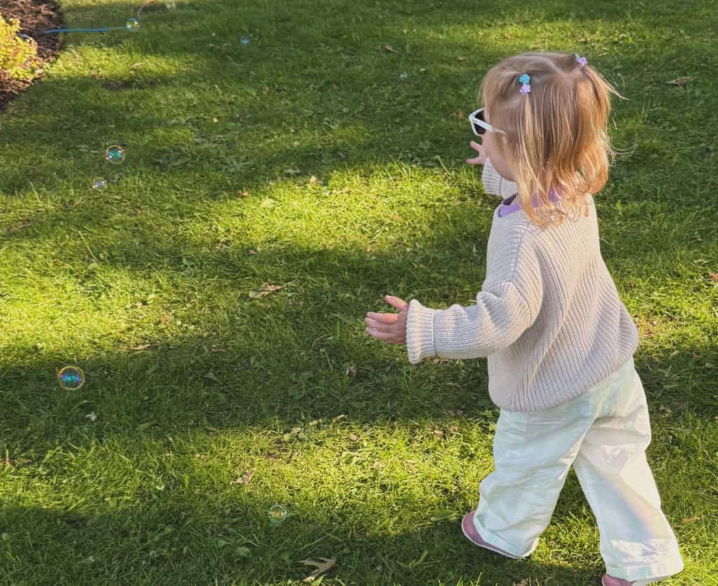 Child chases bubbles at the Oak Bay Night Market in Greater Victoria, BC.