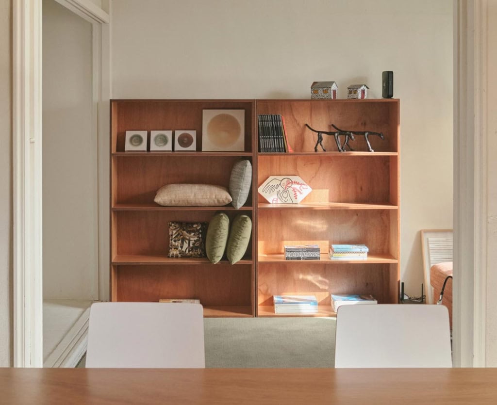 Bookshelf with a number of decor staging items.